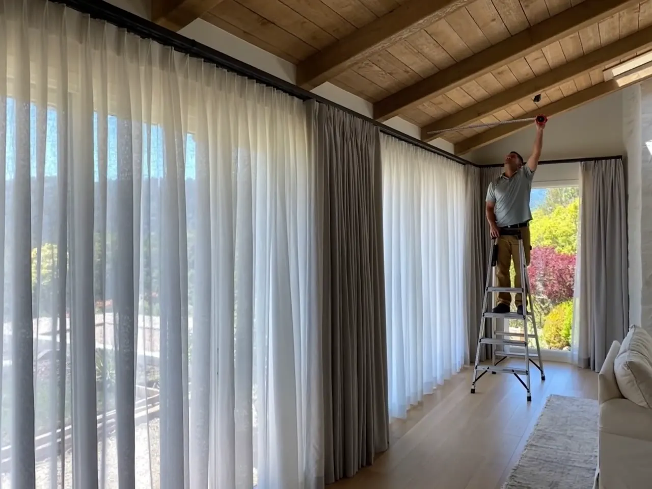 Installer working on a large window covering installation