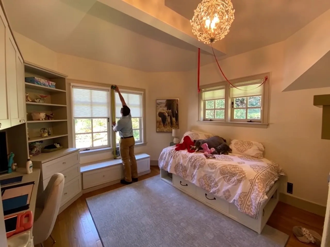 Installer completing window coverings in a residential room
